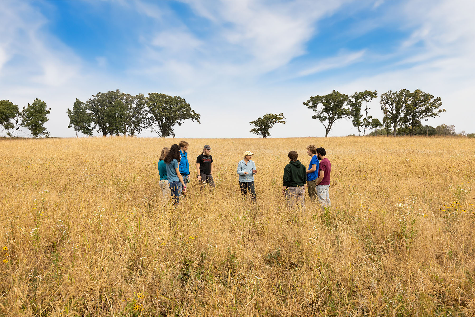 arb director talking to student naturalists in an open field